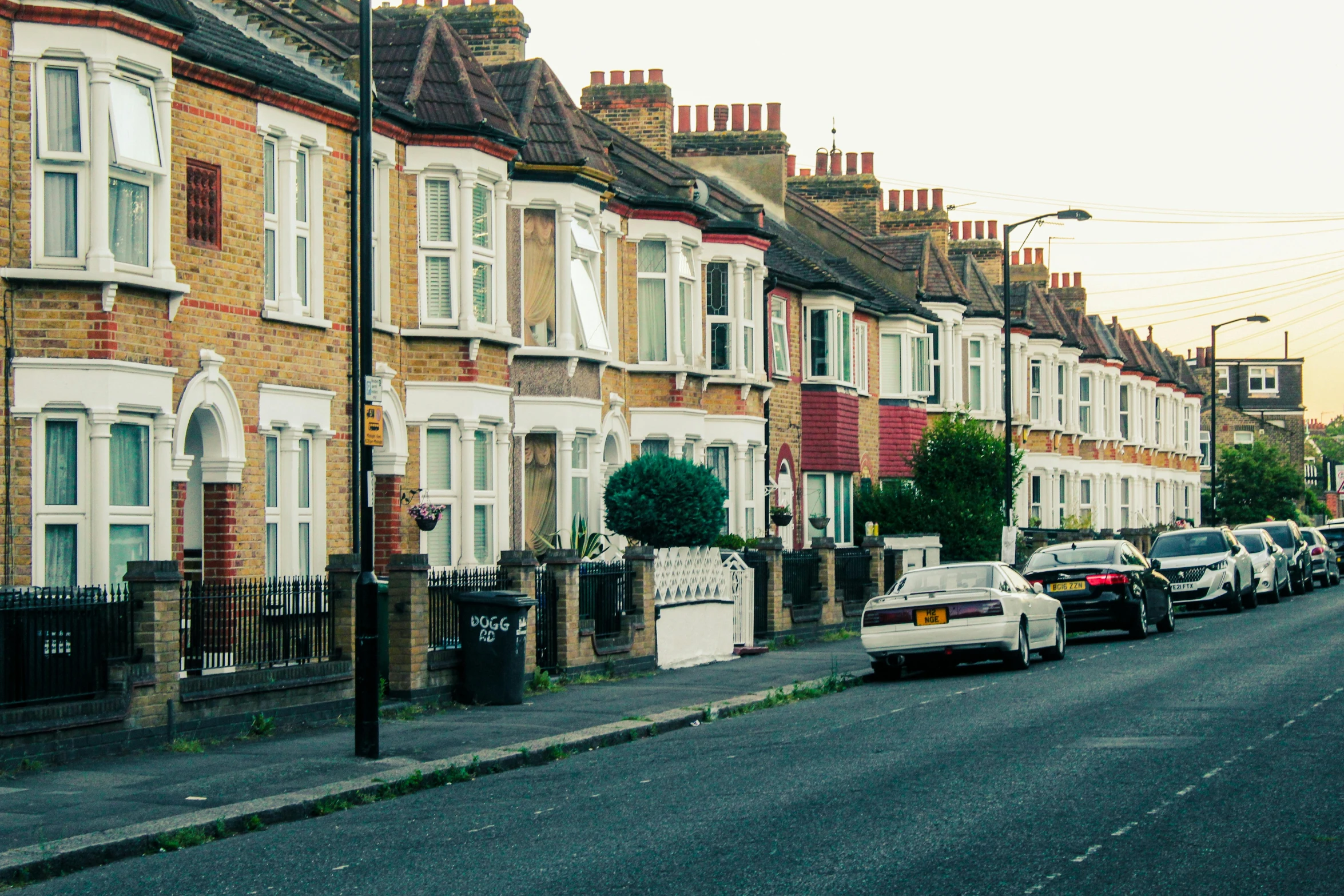 street view of a row of houses along side a busy street