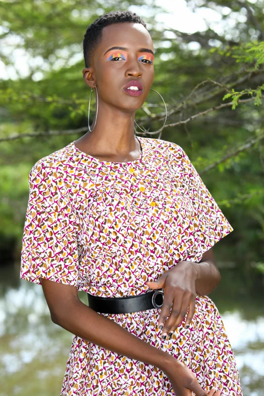 a woman in a floral dress with her eyes painted brown