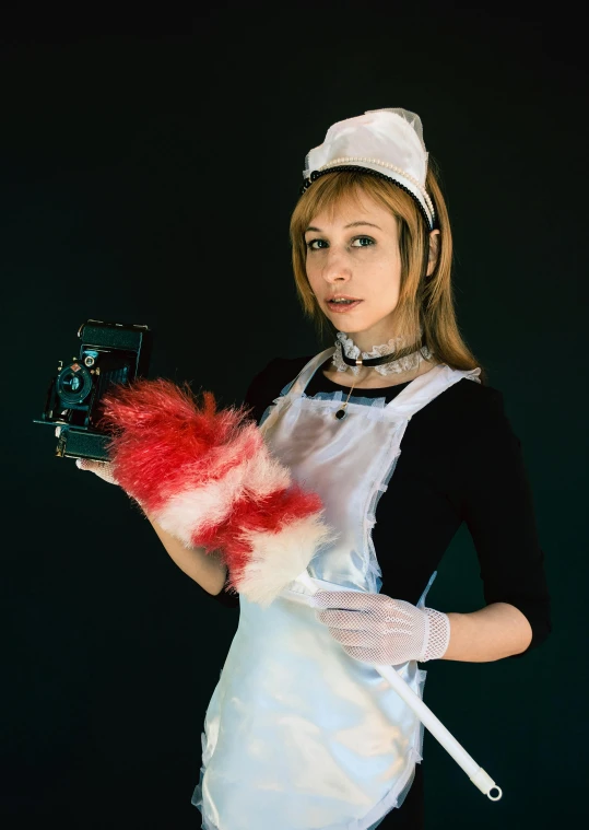 a woman dressed in an apron holding a glove