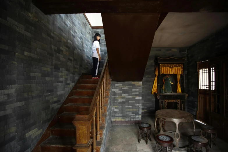 a woman standing on top of a set of stairs