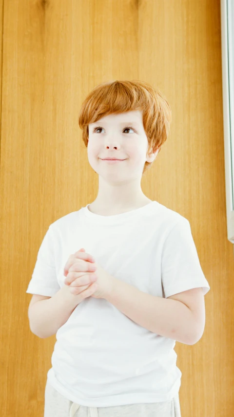 a  in a white shirt standing with his hands crossed