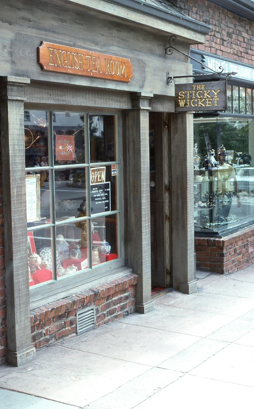 this store front has large wooden beams and windows