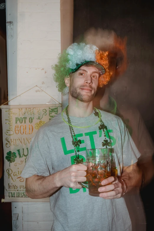 the man is holding a glass of liquid