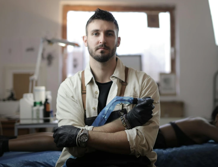 a man wearing safety gloves sits in his room
