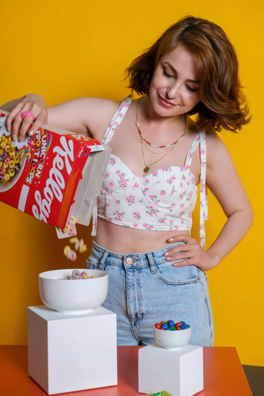 a young woman standing next to a bowl of cereal