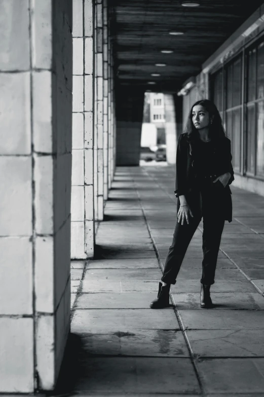 a woman is leaning against the wall on a building