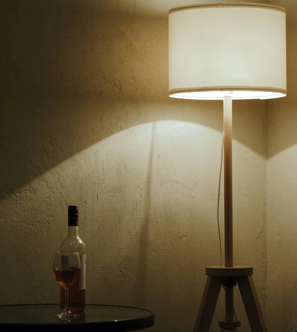 an empty bottle and a lamp on a table