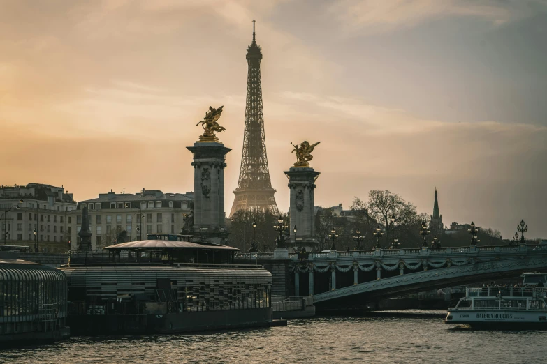 a bridge that has statues on top next to it