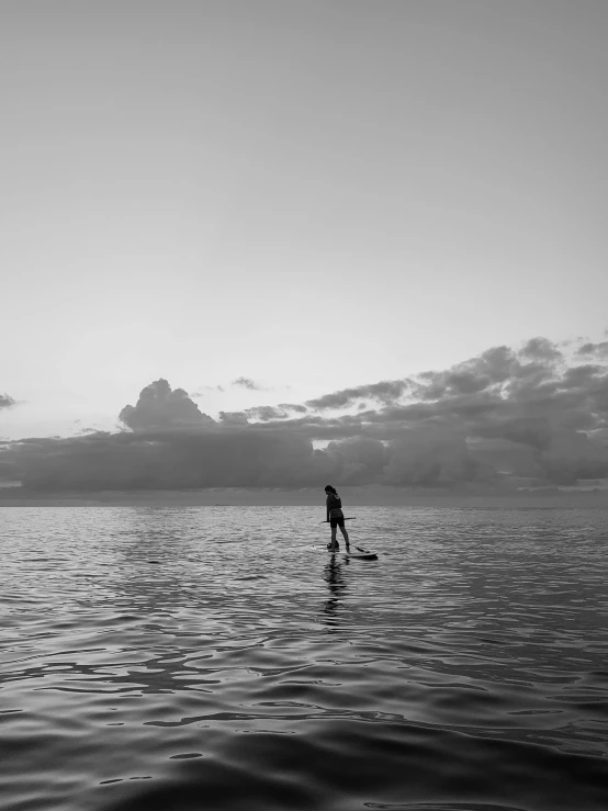 a person riding a surfboard on top of a body of water