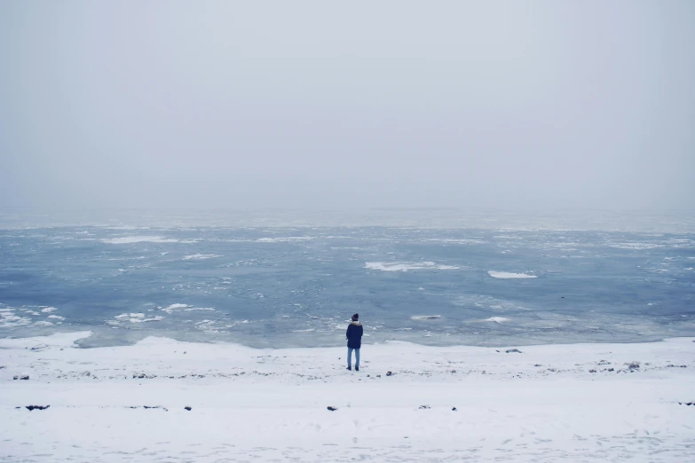 the lone person is watching the big waves