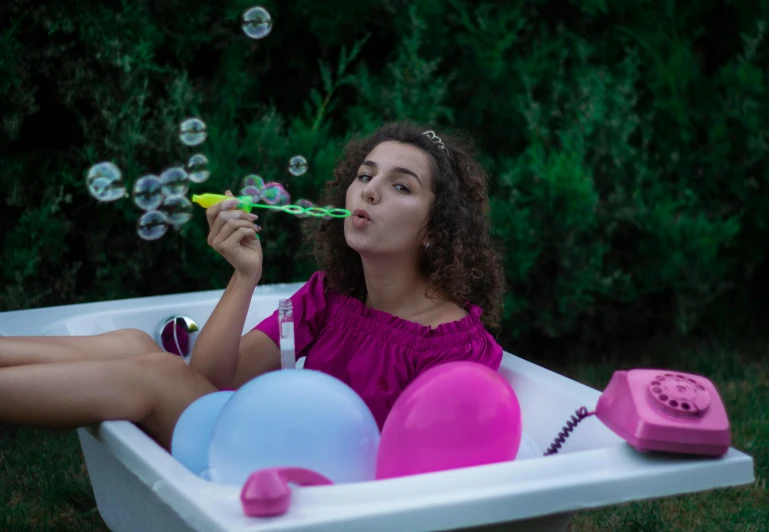 a beautiful young woman sitting in a bath tub