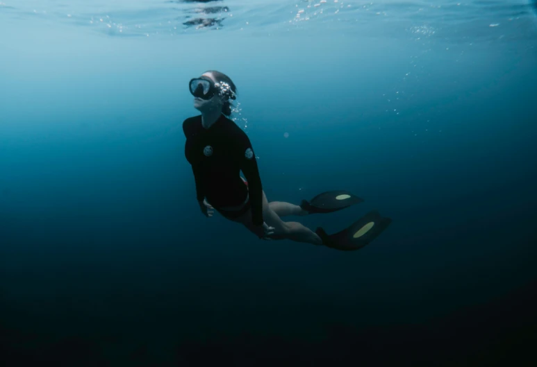 a man in a diving suit is underwater