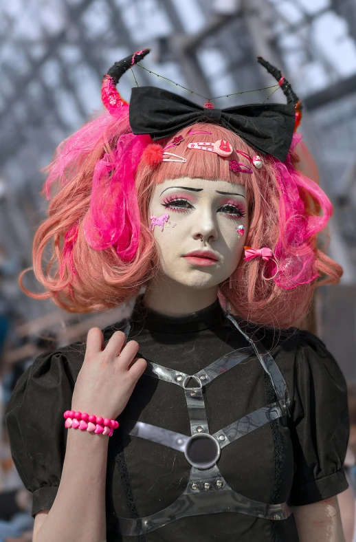 a woman is wearing pink hair and cat costume