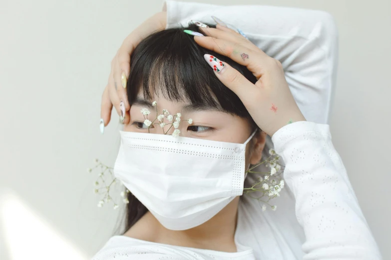 an asian woman has white celets on her shoulder