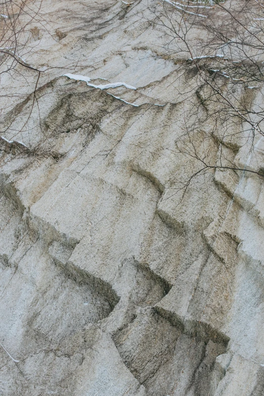 a pile of sand with trees in the background