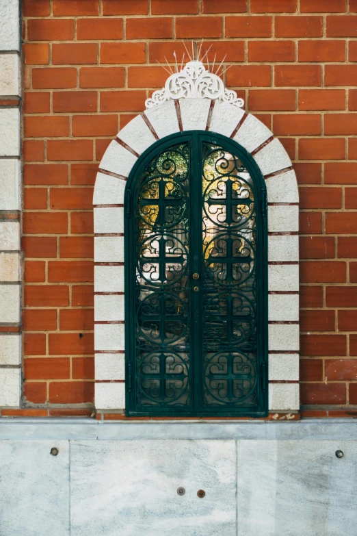 a wall with windows, plants, and a stop sign