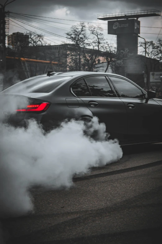 the smoke from the exhaust of a black car