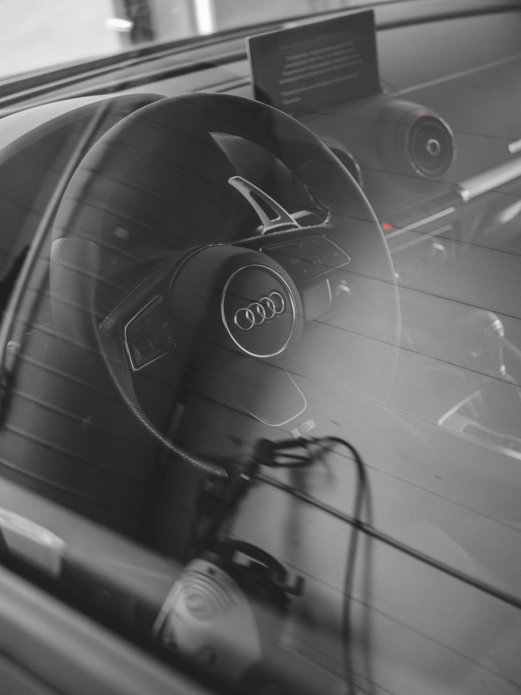 black and white image of steering wheel view of audi