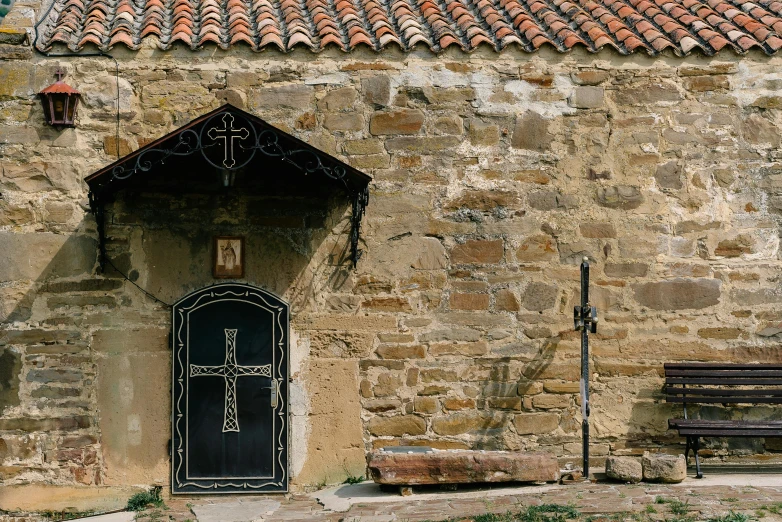 a wooden bench and a brown and white stone building