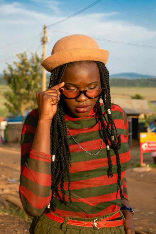 a young woman is walking down the street, with ids on her hair