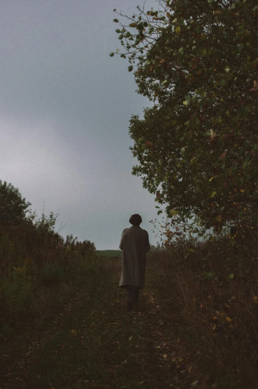 a person walking up a hill in the dark