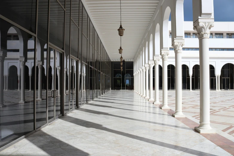 the columns of this hallway are lined with mirrors