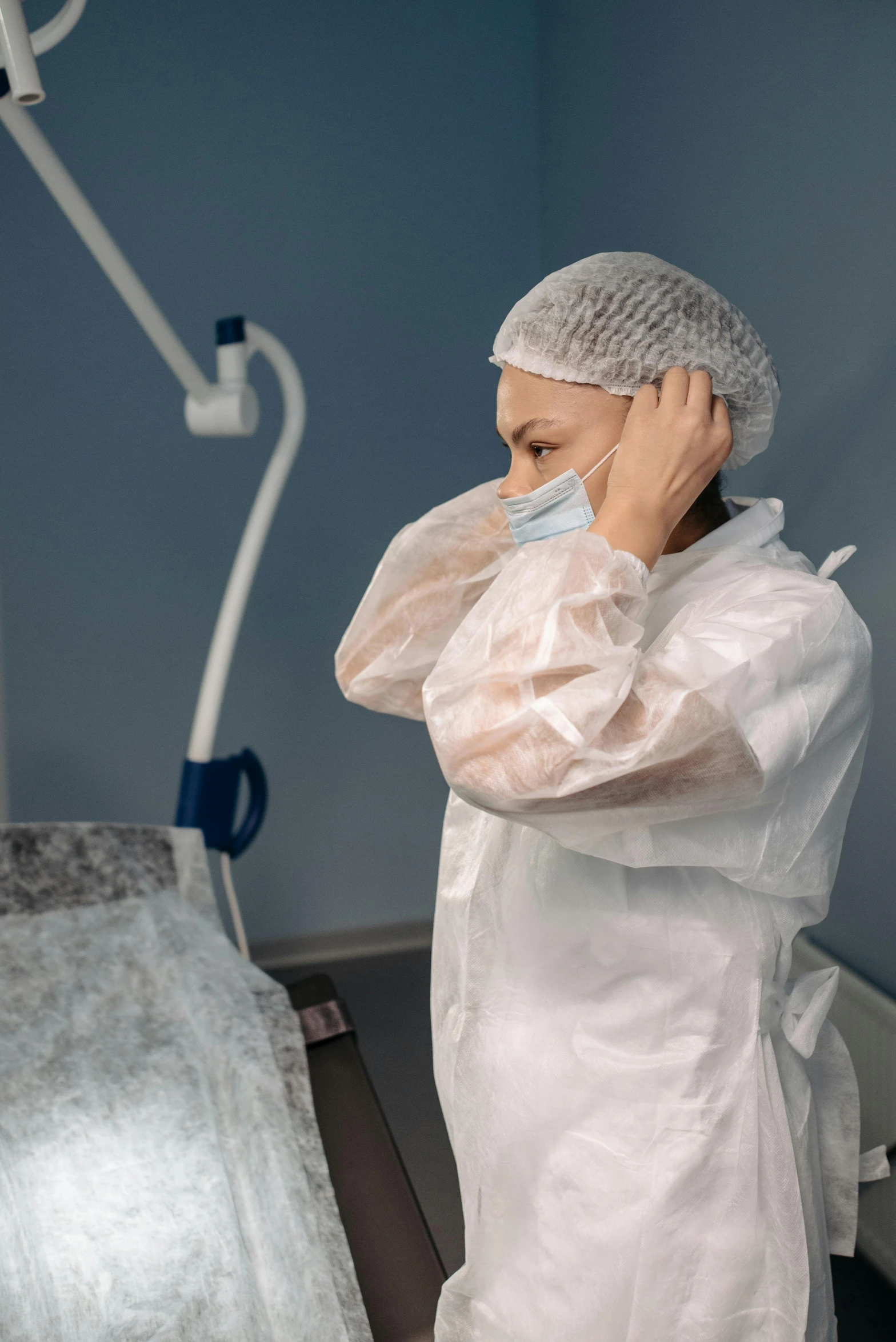 a man wearing a surgical suit and head covering