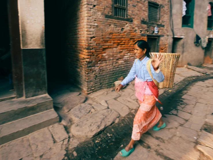 a woman wearing pink and green shoes carries a wicker basket