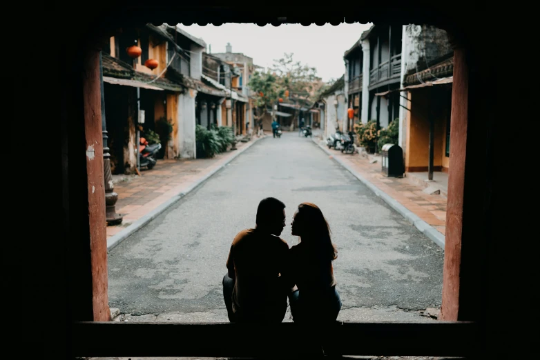 a couple looking out the window at a street