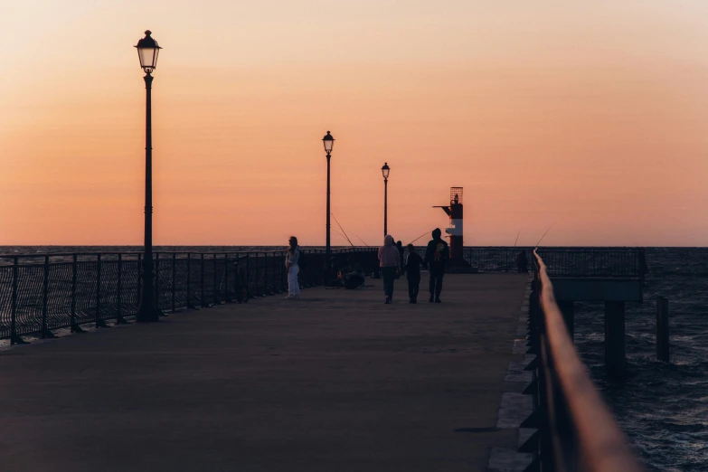 some people walking along the beach while it goes by