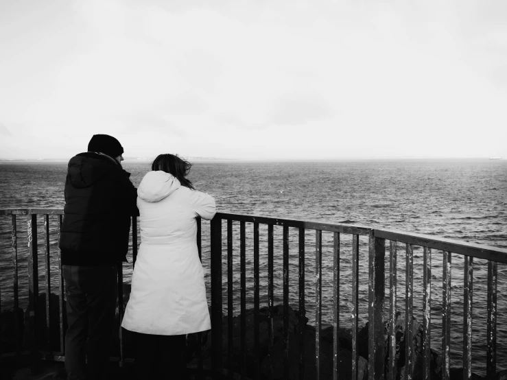 couple looking out over the ocean on a cloudy day