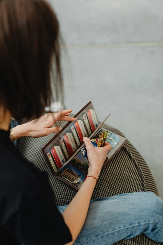 woman sitting on the floor reading and holding onto her book