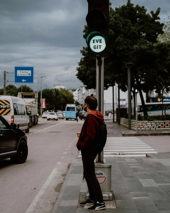 the guy is waiting at the corner for his turn to go