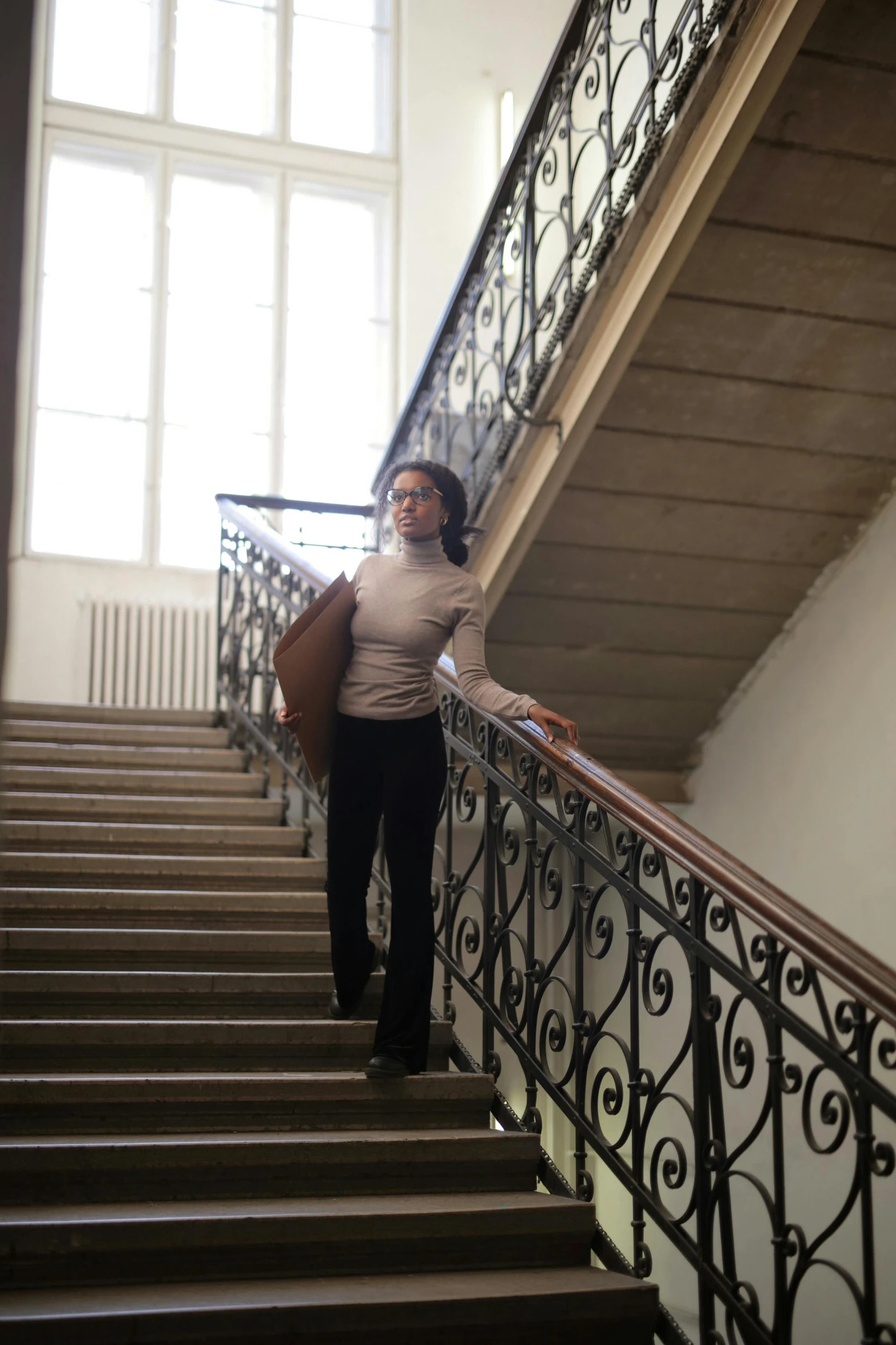 the woman is standing up on the handrails