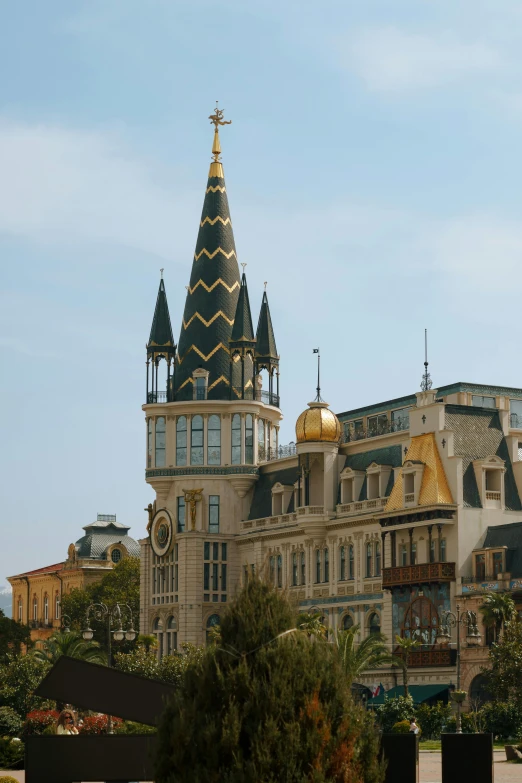 a building with two towers that have gold tops