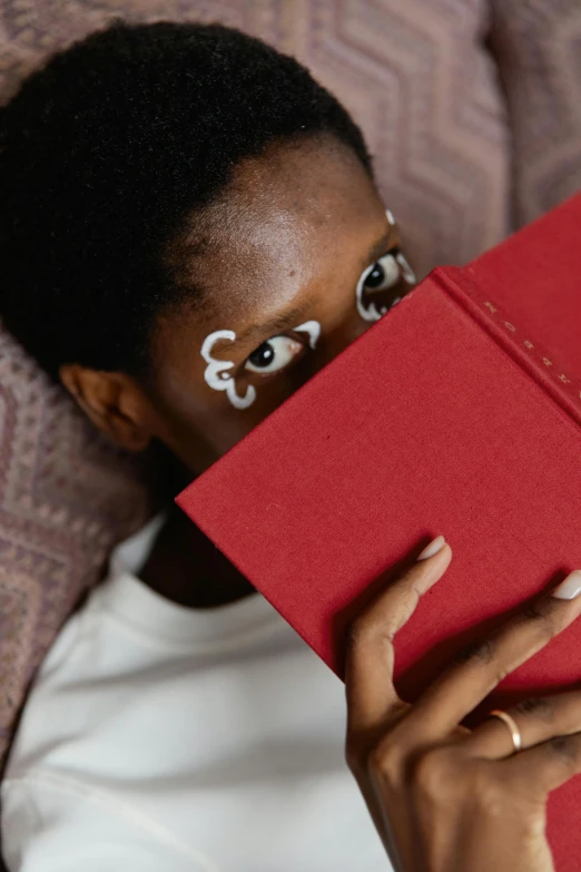 a woman is holding up a red paper