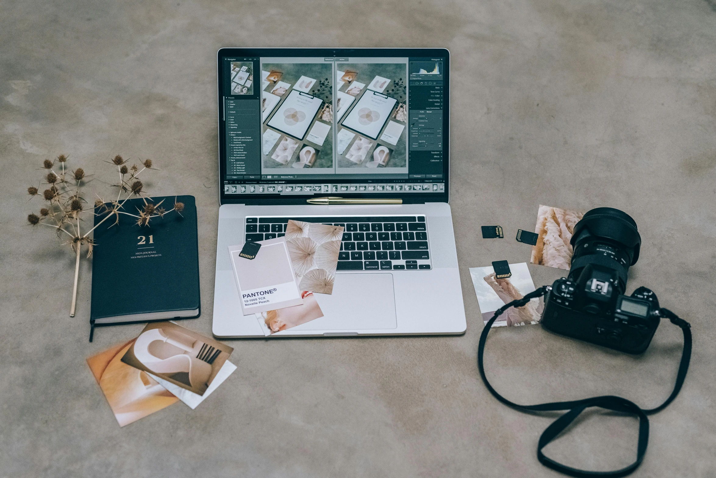 a camera, laptop computer, and other supplies lying on the ground