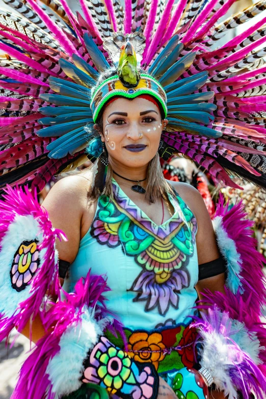 a woman wearing an elaborate head dress and a peacock hat