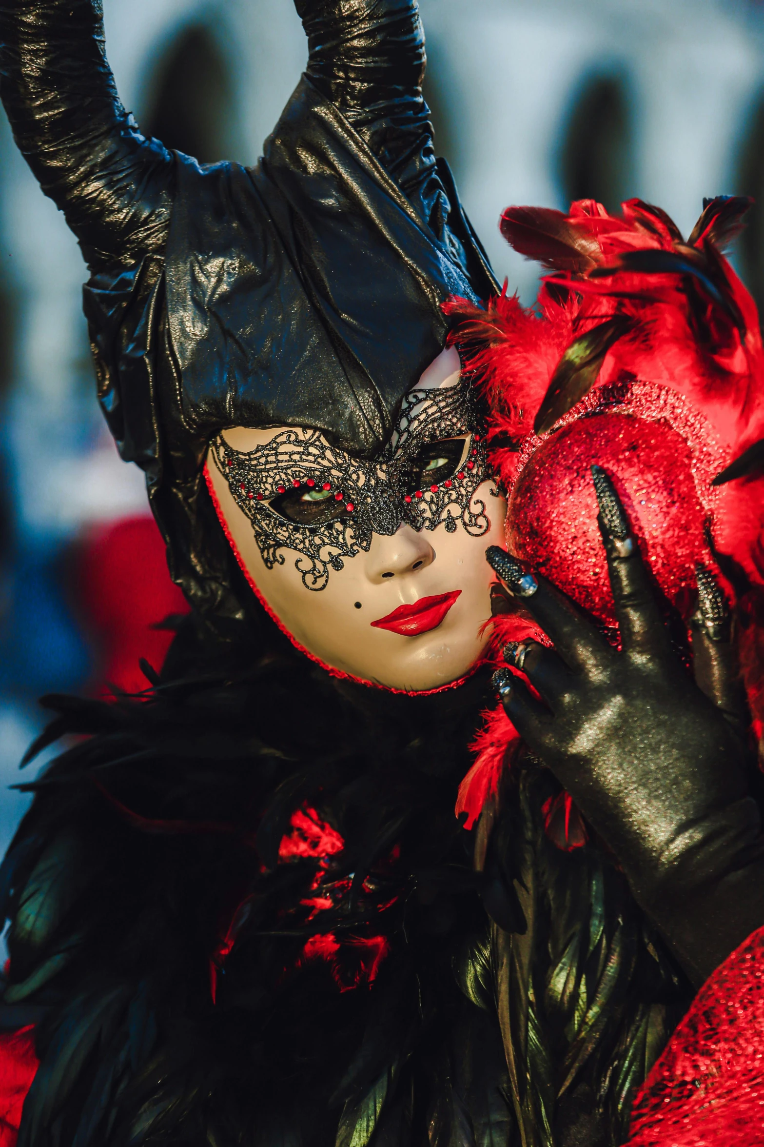 a beautiful red and black costumed woman with horns