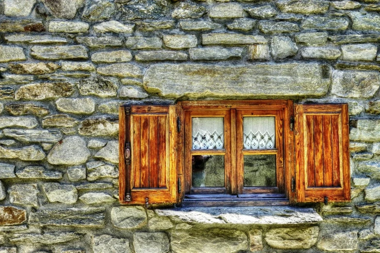 a very cool window in an old stone building