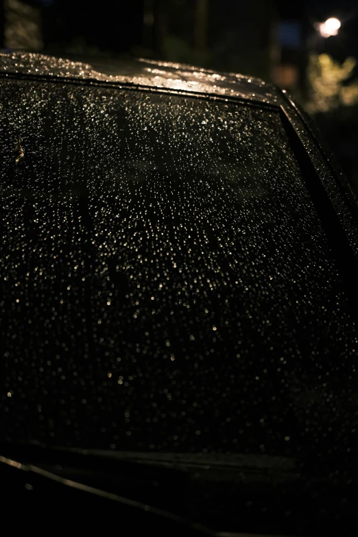 rain is falling on the hood of a car