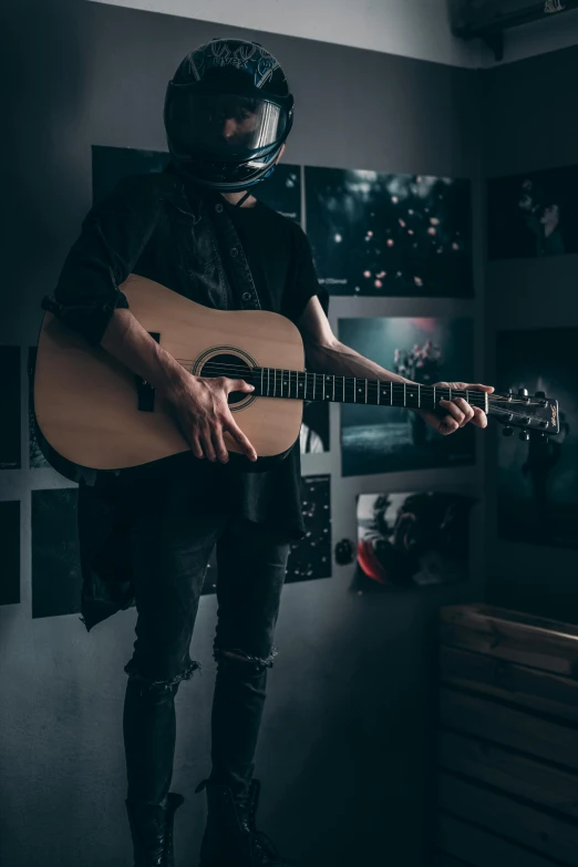 a man in leathers is playing the guitar