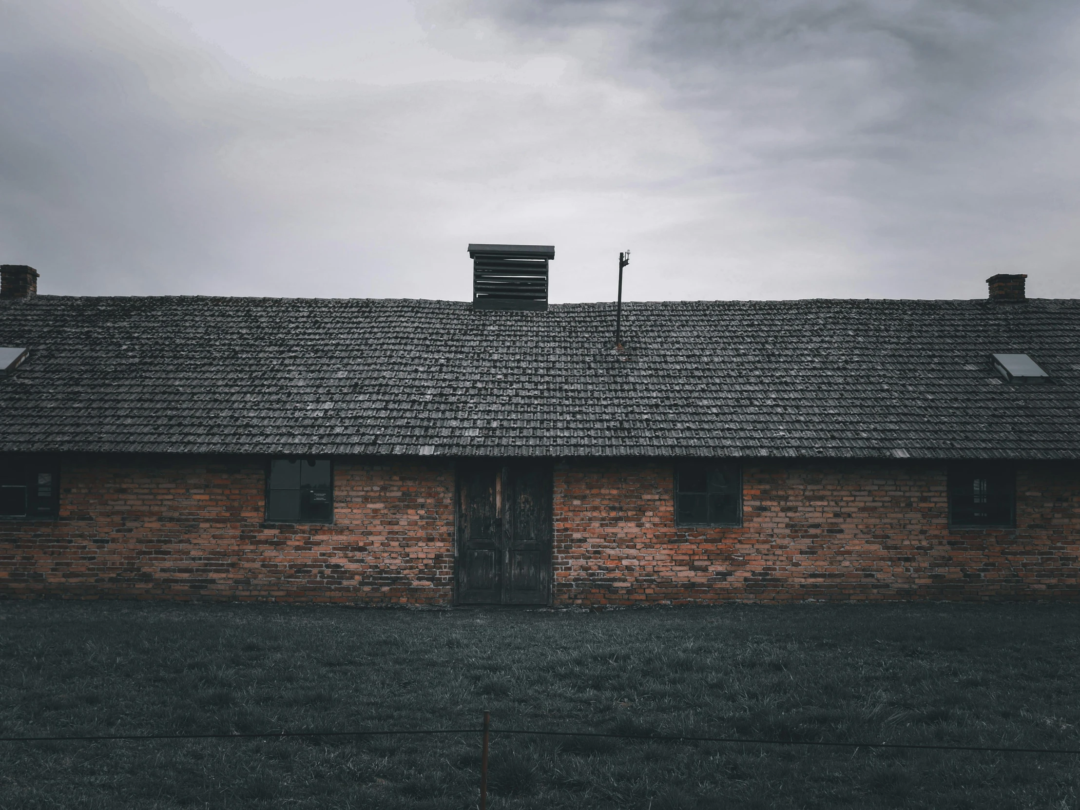 an old brick building with a black door