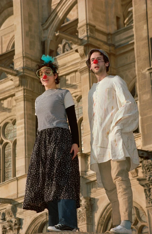 two people standing on ledge with different colors