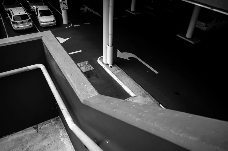 an empty parking lot with two ramps for cars to go into it