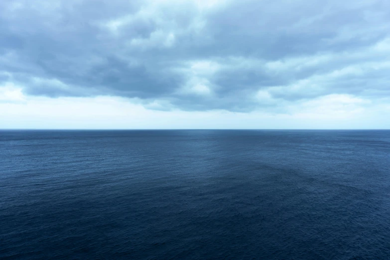 a view of the ocean under a cloudy sky