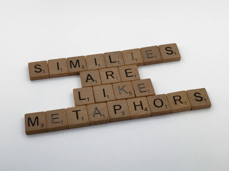 two scrabble tiles spelling smiles, are like metalphors