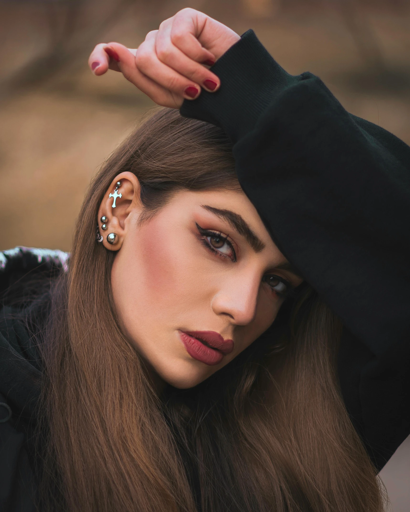 woman with ear piercings looking at camera