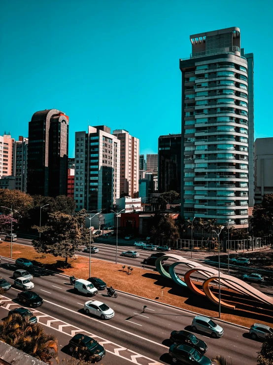 cars on the road next to tall buildings