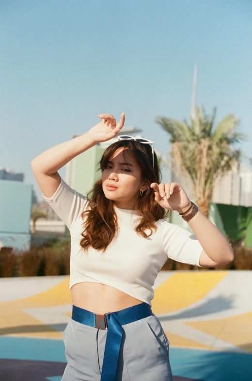 a woman is posing for a po with a sky background